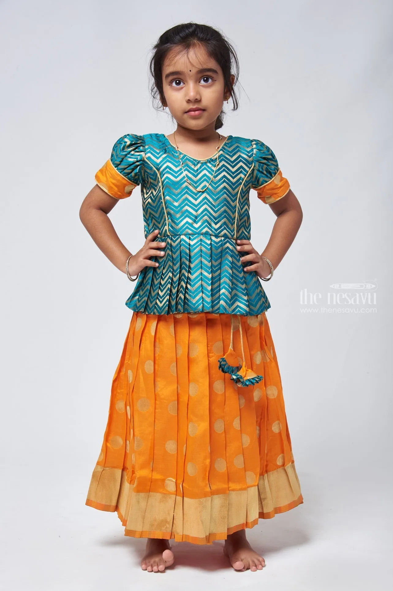 Vibrant Zig Zag Green Peplum Blouse with Zari Butta Orange Pattu Pavadai: Traditional Festive Charm